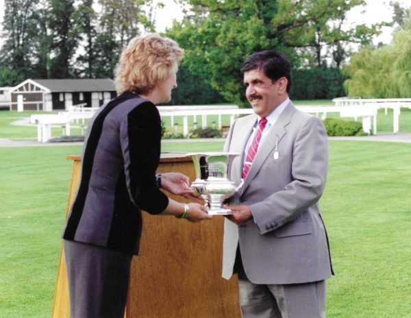 Sheikh Hamdan receiving the trophy for Normativ from Georgie Moore, Chairman of the Racing Committee